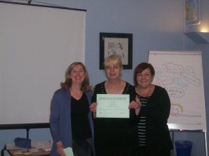 Brenda (centre) receives her certificate from trainers Kim (left) and Vicky (right)
